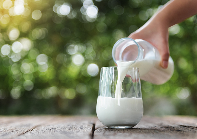 Pouring fresh milk into a glass 